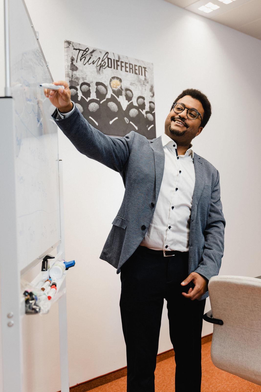 A Dolpheen test architect sketching a test design on a whiteboard